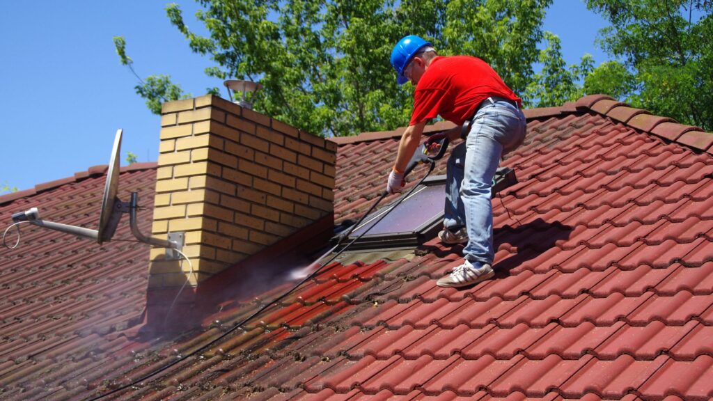 Roofer soft-washing dirty roof