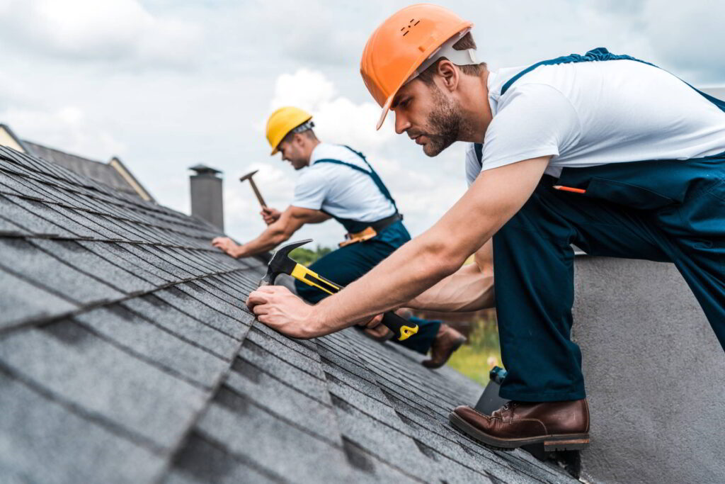 Contractors repairing a roof